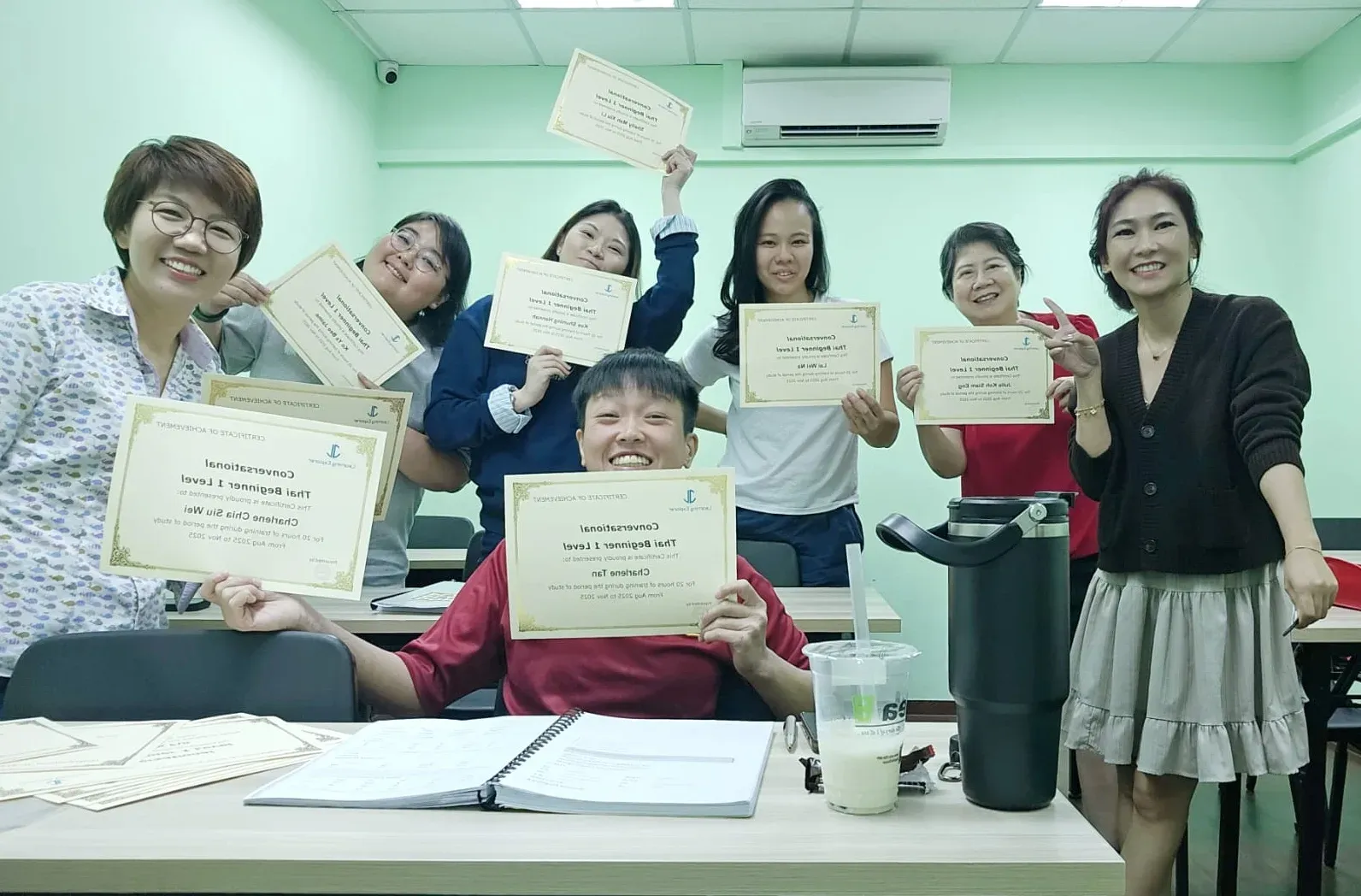 A Thai teacher with her class on completion day