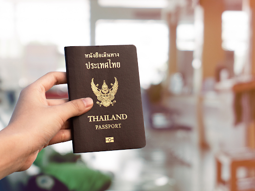 Thai passport held at an airport for travellers learning Thai language basics