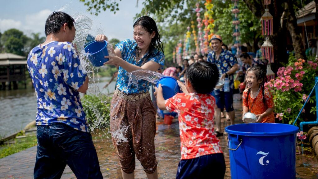 People celebrating Songkran water festival outdoors