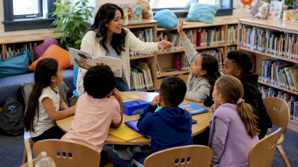 Bilingual teacher interacting with students in classroom