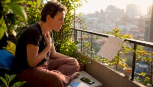 Adult practicing Thai tones at home desk