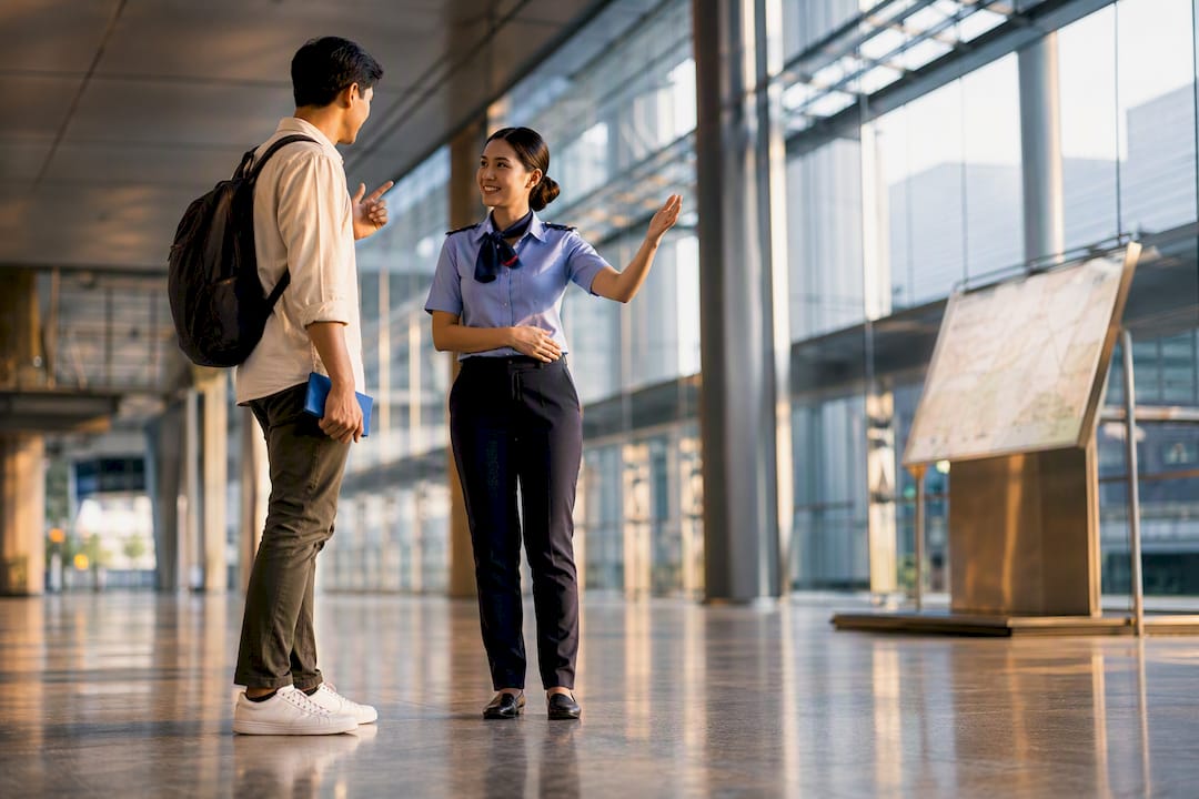 Traveller speaking Thai with station attendant