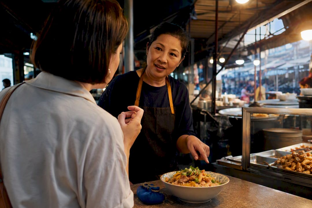 Beginner practising Thai conversation at food market